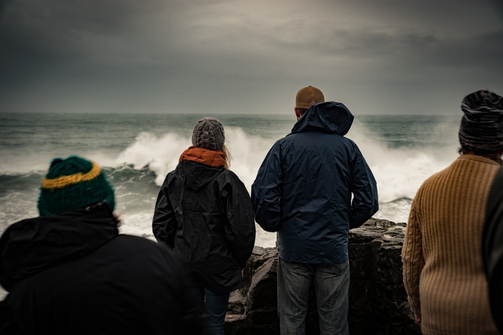 A crowd gathers at a popular storm watching viewpoint in coastal Oregon.