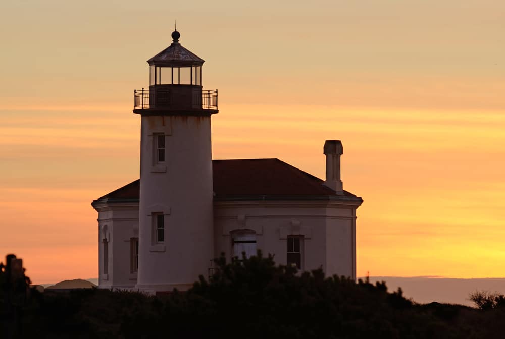 Don't Miss These Oregon Coast Lighthouses 1 Coquille River Lighthouse at sunset is one of the top Oregon Coast Lighthouses to see