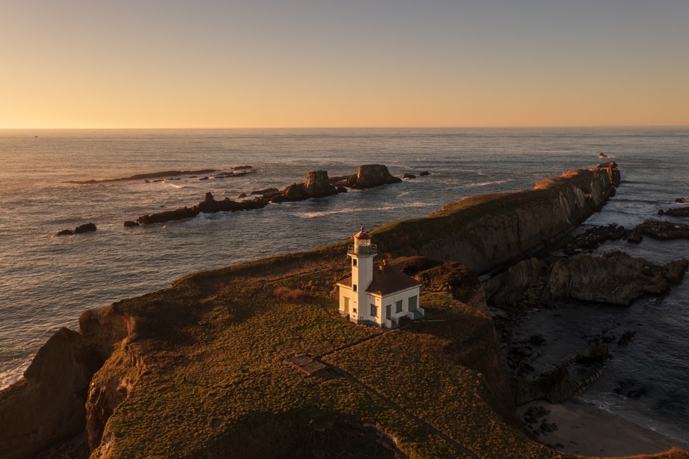 Don't Miss These Oregon Coast Lighthouses 4 Cape Arago Lighthouse at sunset is one of the best Oregon Coast lighthouses near Bandon