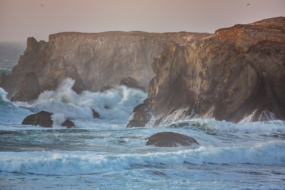 The Best Things to Do in Bandon on a Rainy Day 1 Waves crash against the rocks in Oregon. Storm watching is one of the best things to do in Bandon when it rains.
