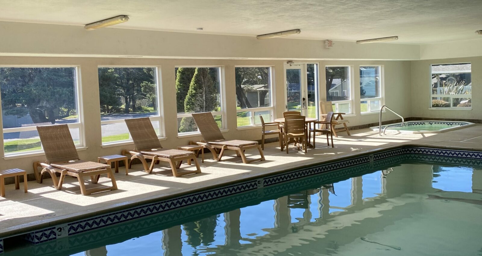 Plan your Oregon Coast Vacations to Bandon 2 The indoor pool and hot tub with lounge chairs at one of the best places to stay on the Oregon Coast.